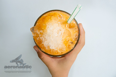 Food Stock Photos - A Hand Holding a Glass of Thai Iced Tea