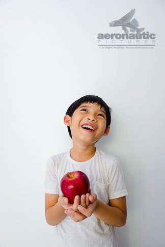 Premium Photo  Surprised kid holding huge apple anti stress