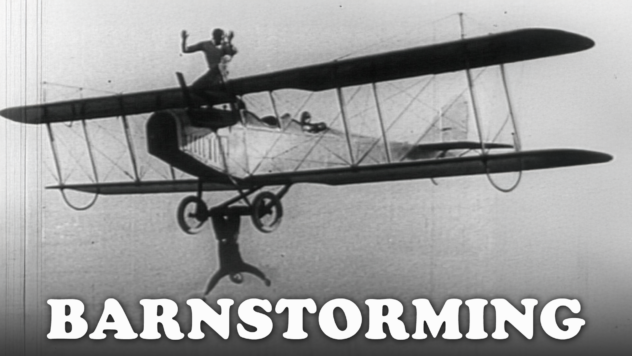 1920s Barnstorming Stock Footage: Wing Walkers & Stunts | Black and white still of 1920s wing walker standing on biplane wing