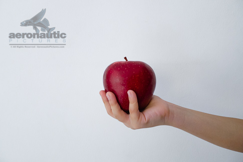 Food Stock Photo - A Child's Hand Holding a Red Delicious Apple Download