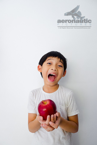 Food Stock Photos - A Happy Kid Holding an Apple Download Royalty Free Cheap