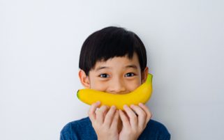 Food Stock Photo - A Kid and a Banana Smile Download Royalty Free