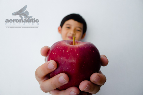 Food Stock Photo - A Kid Giving You a Red Delicious Apple Download Cheap