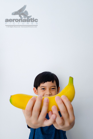 Food Stock Photo - A Kid Holding a Banana Download Royalty Free