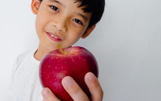 Apple Stock Photo - A Kid Holding a Red Delicious Apple